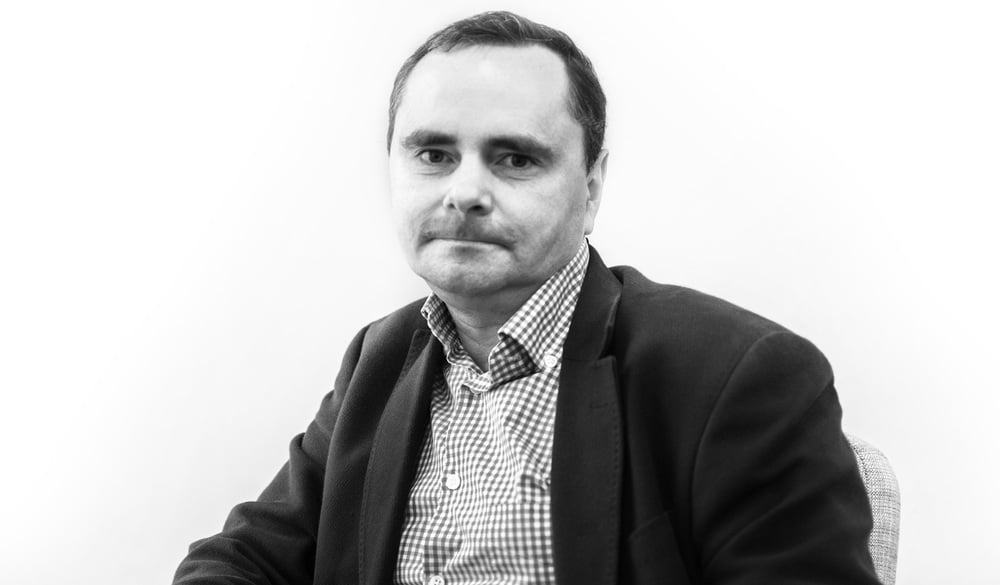 Professor Ladislav Timulak who is wearing a black blazer and checkered shirt.