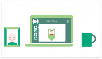 A laptop showing the Silver Cloud website next to a framed photo of a baby and a mug.