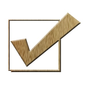 A wooden checkmark in a box.
