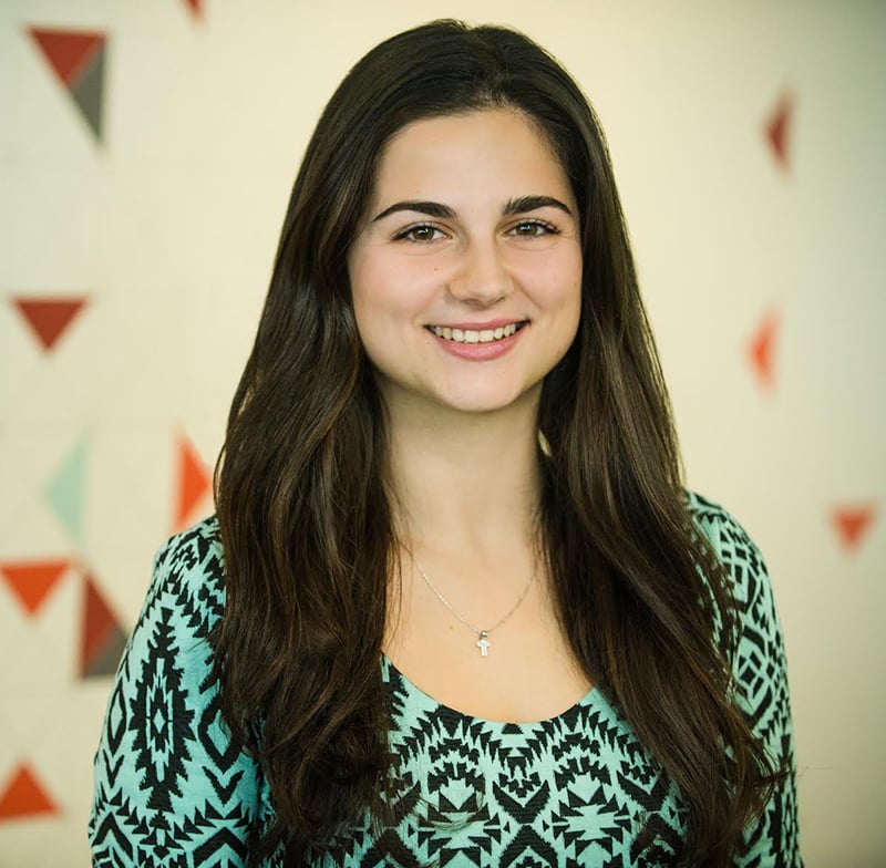 Catalina Cumpanasoiu, who is a clinical research associate at SilverCloud health, is a green and black blouse.