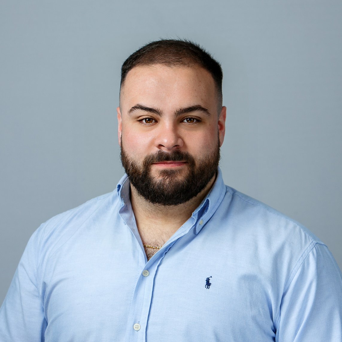 Daniel Duffy who is a clinical trials associate at SilverCloud Health and is wearing a blue button down shirt.